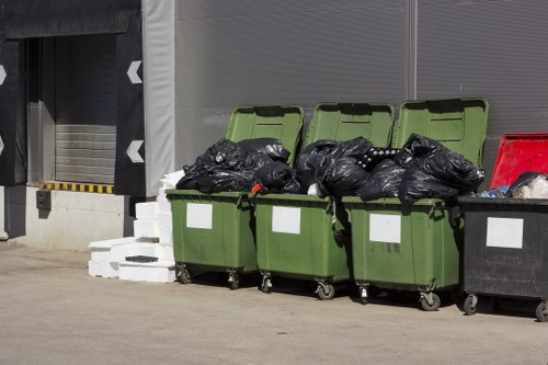 Workers loading bulky items into a truck for disposal